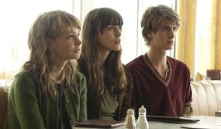 Never Let Me Go Carey Mulligan Keira Knightley Andrew Garfield sitting at a table, looking up expect