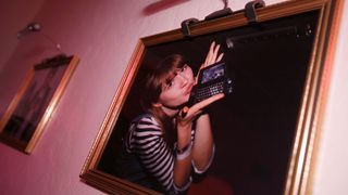 T-Mobile Sidekick held by a girl in a frame