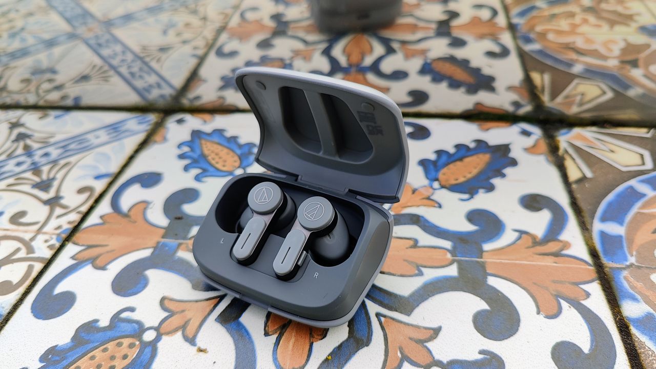 Audio-Technica ATH-TWX7 review: true wireless earbuds in charging case on patterned tile