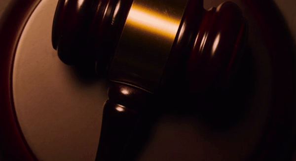 A gavel spins on a stand. 