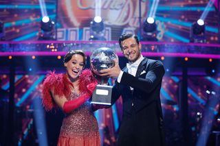 Ellie Leach and Vito Coppola holding the Strictly Come Dancing glitterball trophy.