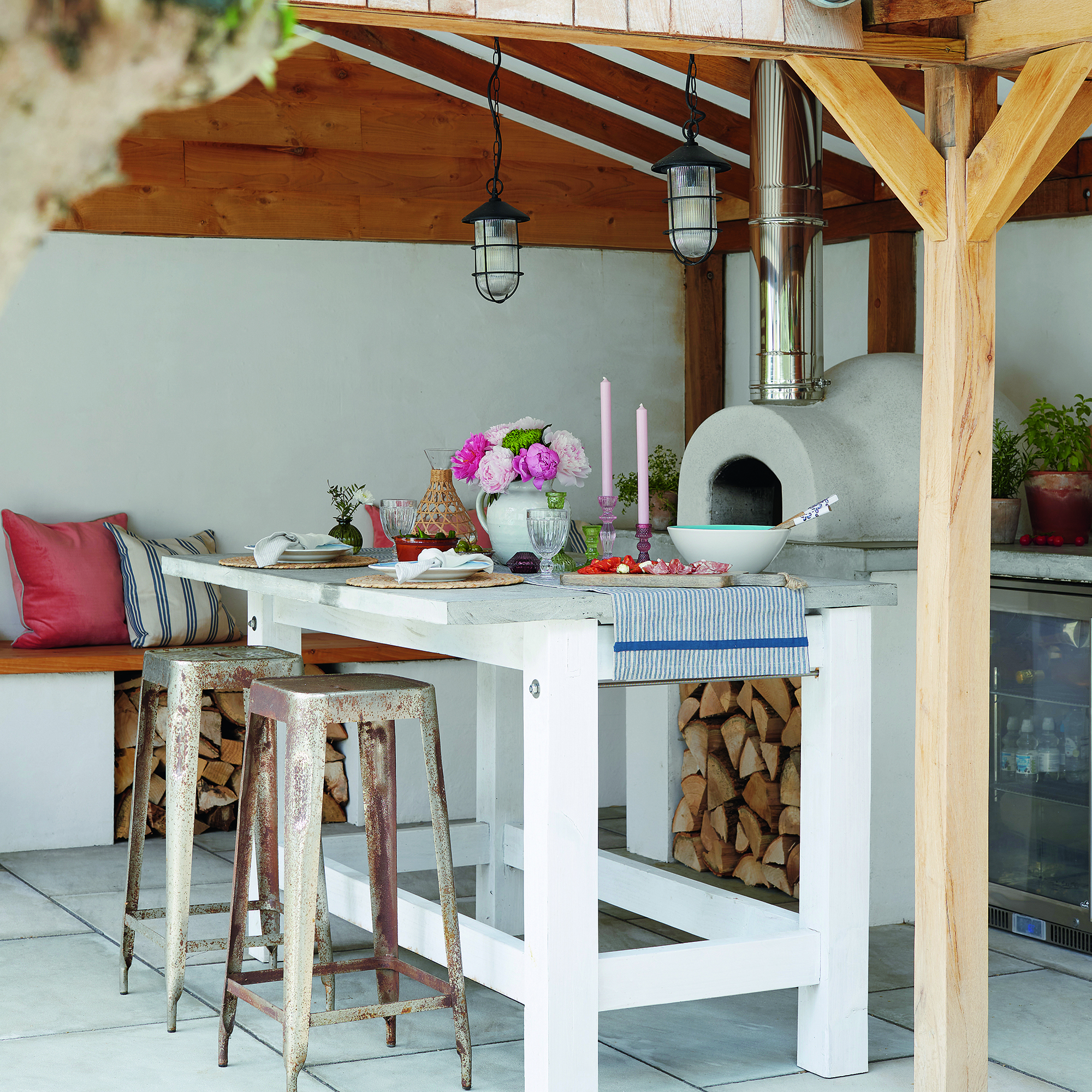 Outdoor kitchen with pendant lights over island