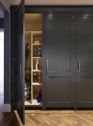 A close up of some dark floor to ceiling cabinets with storage inside