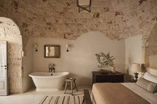 rustic bedroom with bathtub