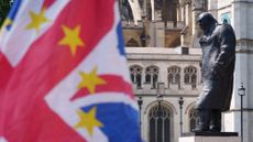A Union Jack with EU stars waving beside a statue of Winston Churchill at the regular anti-Brexit protest in Westminster