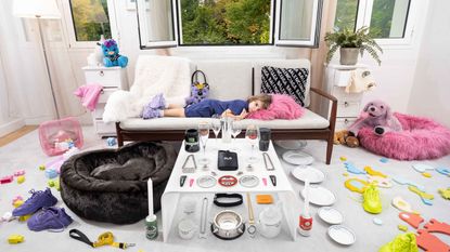 Child on sofa surrounded by Balenciaga Objects
