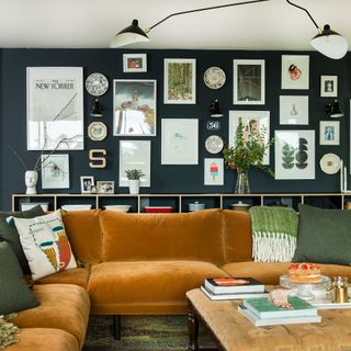 living room with velvet sofa wall frame and glass vase