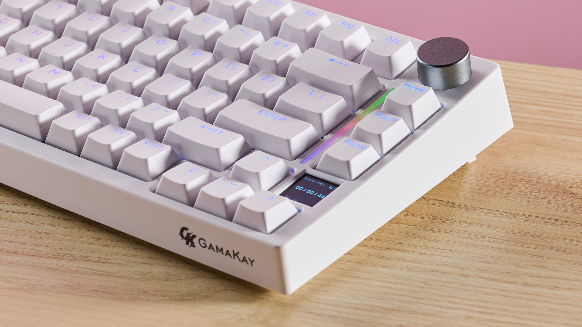 Close-up of right side of Gamakay TK75HE V2 on desk with pink wall in background
