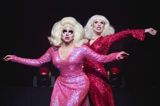 drag stars Trixie Mattel and Katya Zamolodchikova in pink dresses and blonde wigs on stage performing