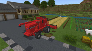 A screenshot from the Farmcraft competition showing a computer animated red tractor tilling a field of produce.