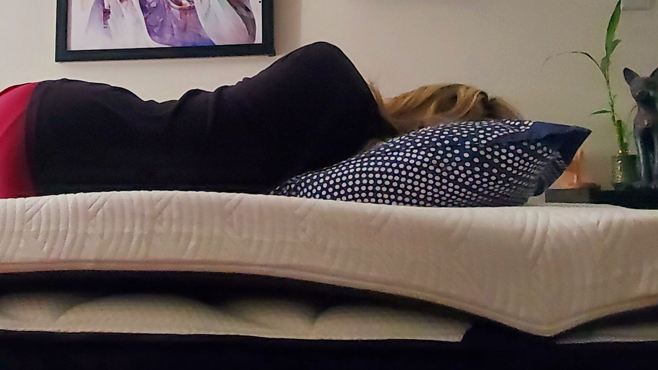 A blonde tester sleeps on her side on the Viscosoft Active Cooling Mattress Topper.