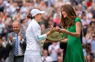 Kate Middleton handing a trophy to a tennis player at Wimbledon