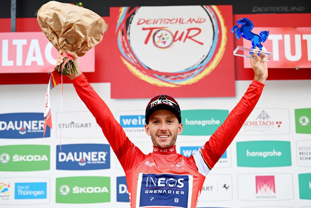 STUTTGART GERMANY AUGUST 28 Adam Yates of United Kingdom and Team INEOS Grenadiers Red Leader Jersey celebrates at podium as overall race winner during the 37th Deutschland Tour 2022 Stage 4 a 1866km stage from Schiltach to Stuttgart DeineTour on August 28 2022 in Stuttgart Germany Photo by Stuart FranklinGetty Images