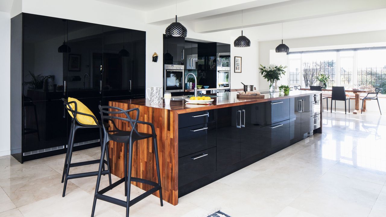 contemporary kitchen extension in period home with monochrome scheme and statement cental island image by james french