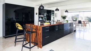 Designing a single storey extension: a contemporary kitchen extension in period home with monochrome scheme and statement cental island image by james french