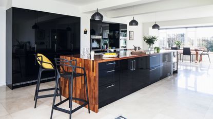 contemporary kitchen extension in period home with monochrome scheme and statement cental island image by james french