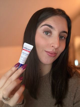 Marisa holding the Aquaphor Immediate Relief Lip Treatment