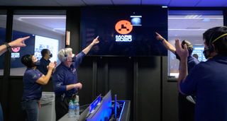 Members of NASA’s Perseverance Mars rover team watch in mission control as the first images arrive moments after the spacecraft successfully touched down on Mars, Thursday, Feb. 18, 2021, at NASA's Jet Propulsion Laboratory in Pasadena, California.
