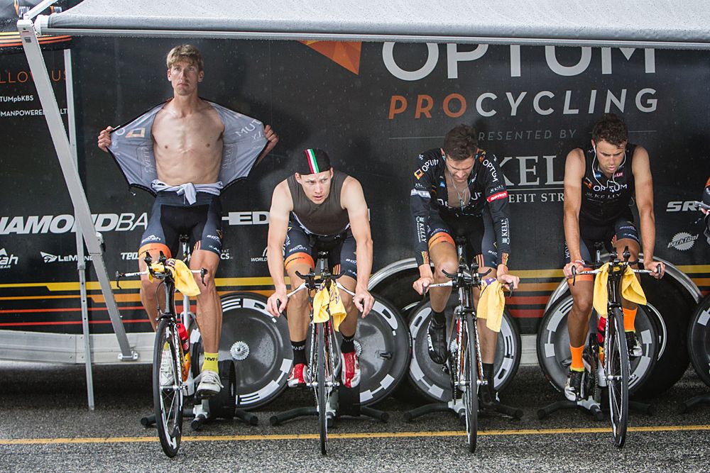 Optum men take cover from the rain to warm up