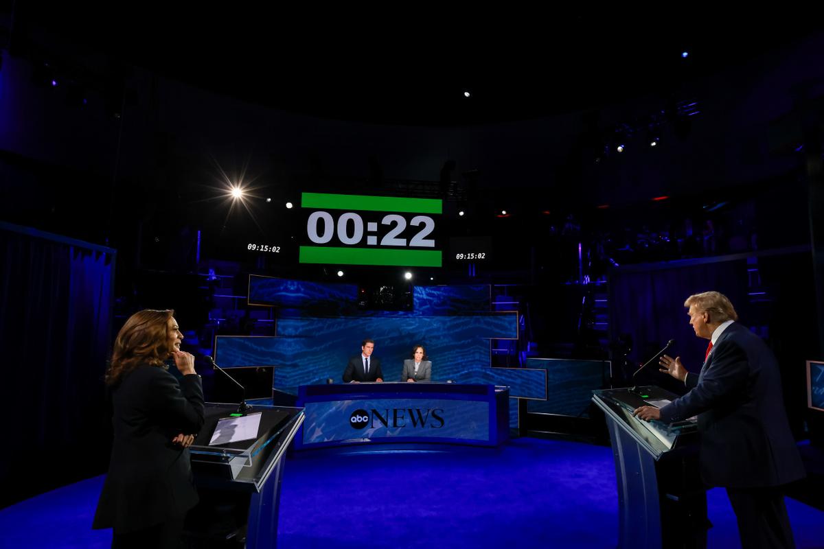 ABC News debate showing moderators and back of Trump and Harris. 