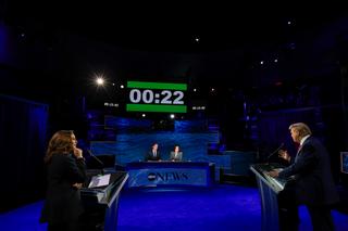 ABC News debate showing moderators and back of Trump and Harris. 