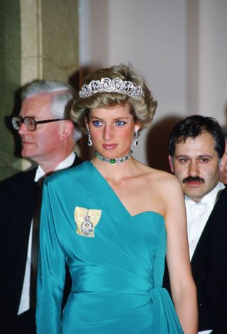 Princess Diana attends a banquet at Claridges Hotel in London wearing the Spencer Tiara and Queen Mary's emerald and diamond choker