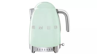 An eggshell Smeg kettle with variable temperature controls on a white background