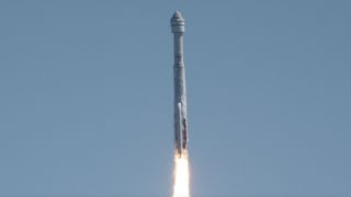 closeup view of a white rocket climbing into a blue sky