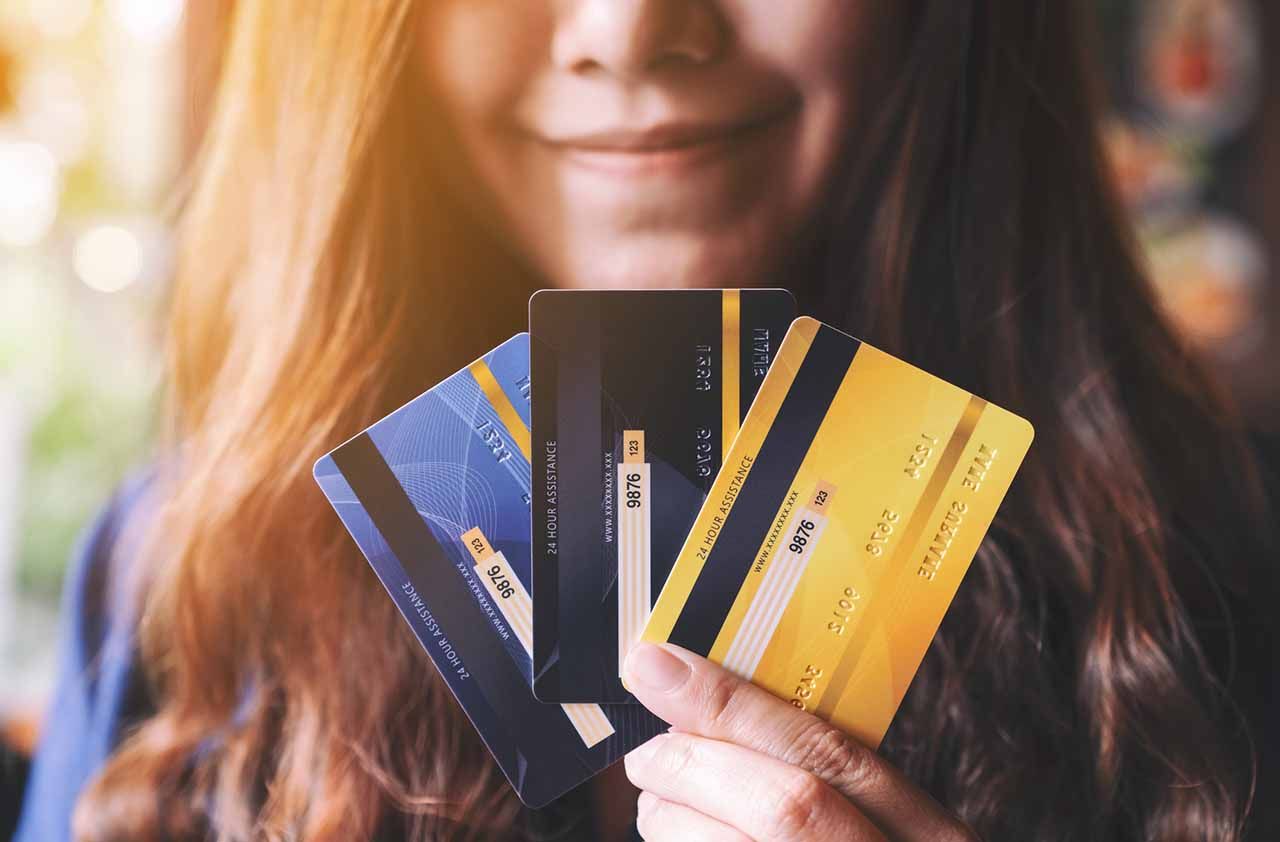 Closeup image of a woman holding and showing credit cards