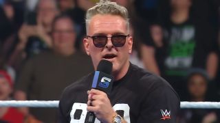 Pat McAfee on the microphone after entering the ring