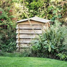 Wooden compost bin shaped like beehive