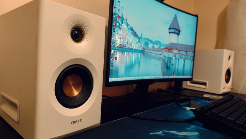 White Edifier MR5 speakers on a black desk