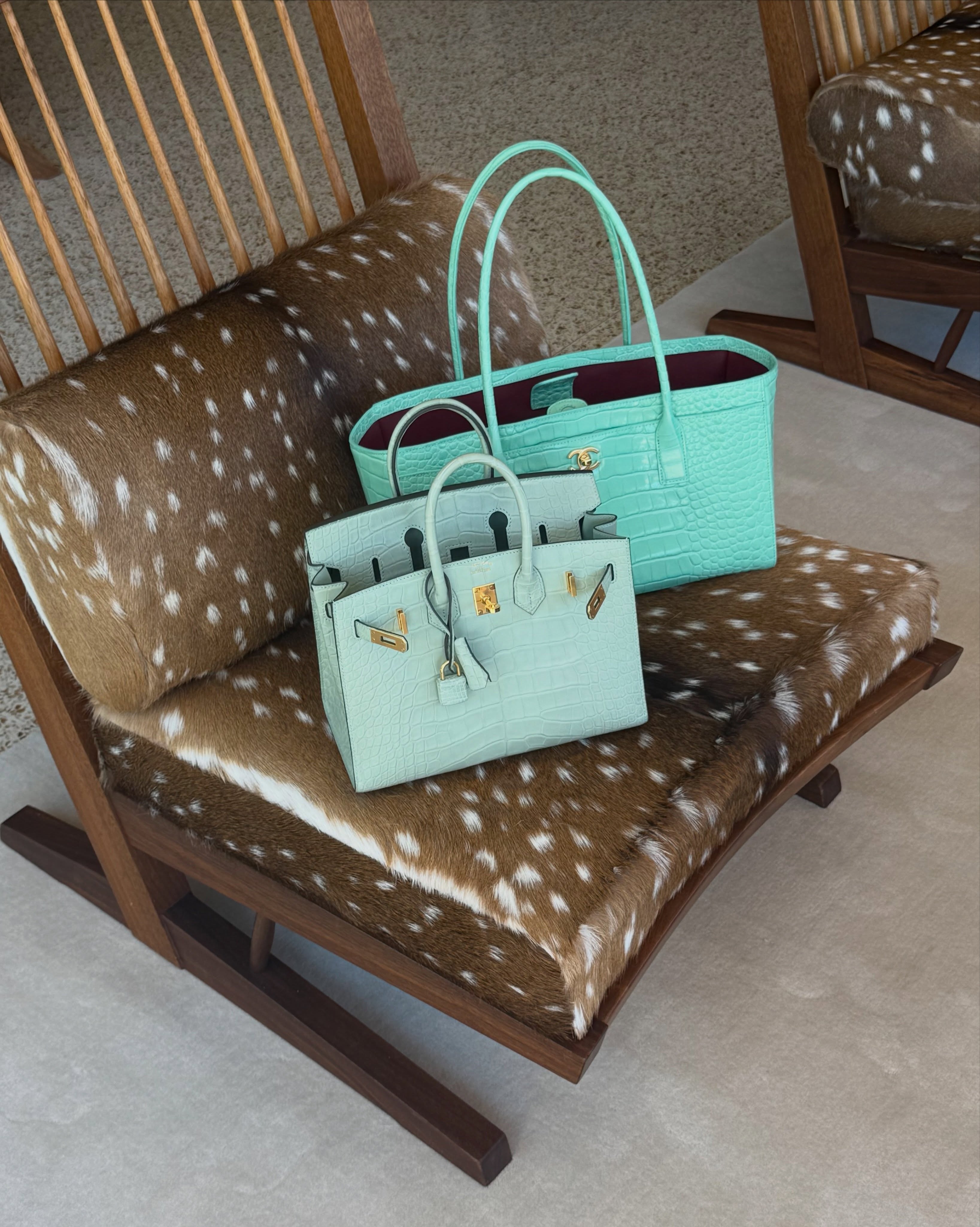 An image of two teal bags, one from Chanel and one from Herm&amp;egrave;s.
