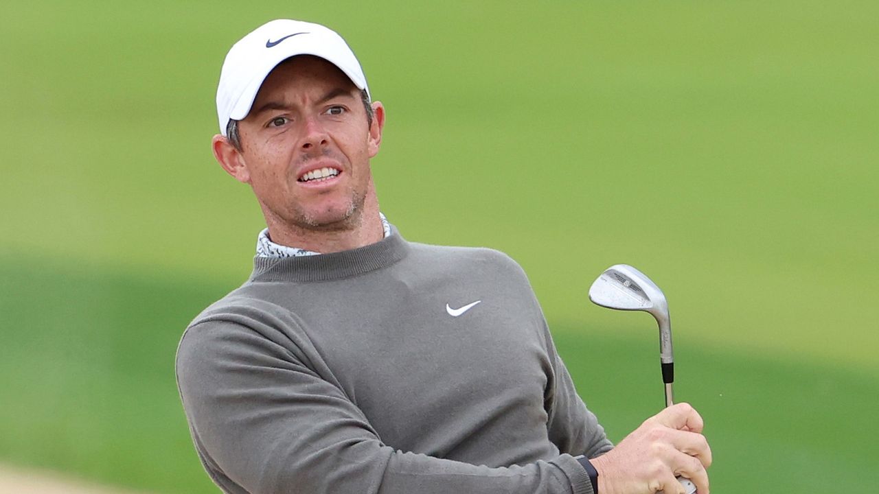 Rory McIlroy looks on after hitting a wedge shot