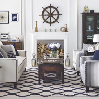 living room with blue and white rug and sofaset with cushions