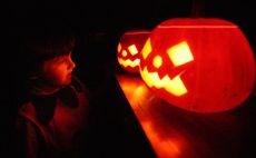 LONDON - OCTOBER 31:A child enjoys traditional candle-lit Halloween pumpkins on October 31, 2007 in London.(Photo by Peter Macdiarmid/Getty Images)