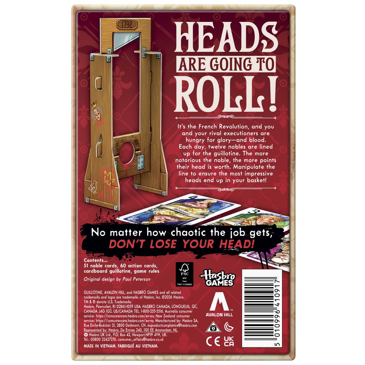 Guillotine box, cards, and prop on a plain background