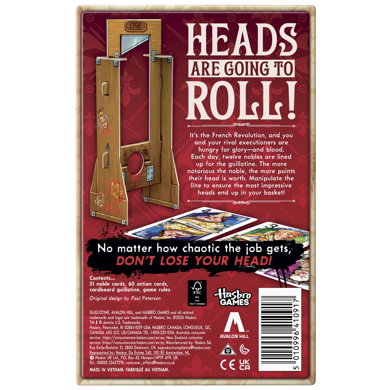 Guillotine box, cards, and prop on a plain background