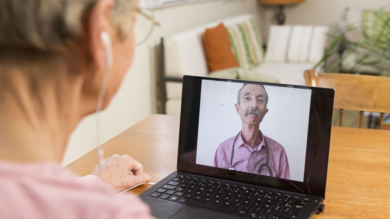 A woman attends a remote GP appointment 