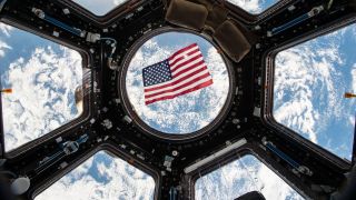 u.s. flag against a multi-frame window with the earth below