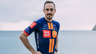 Picnic-PostNl's jersey has two orange horizontal stripes down the front with a dark blue background