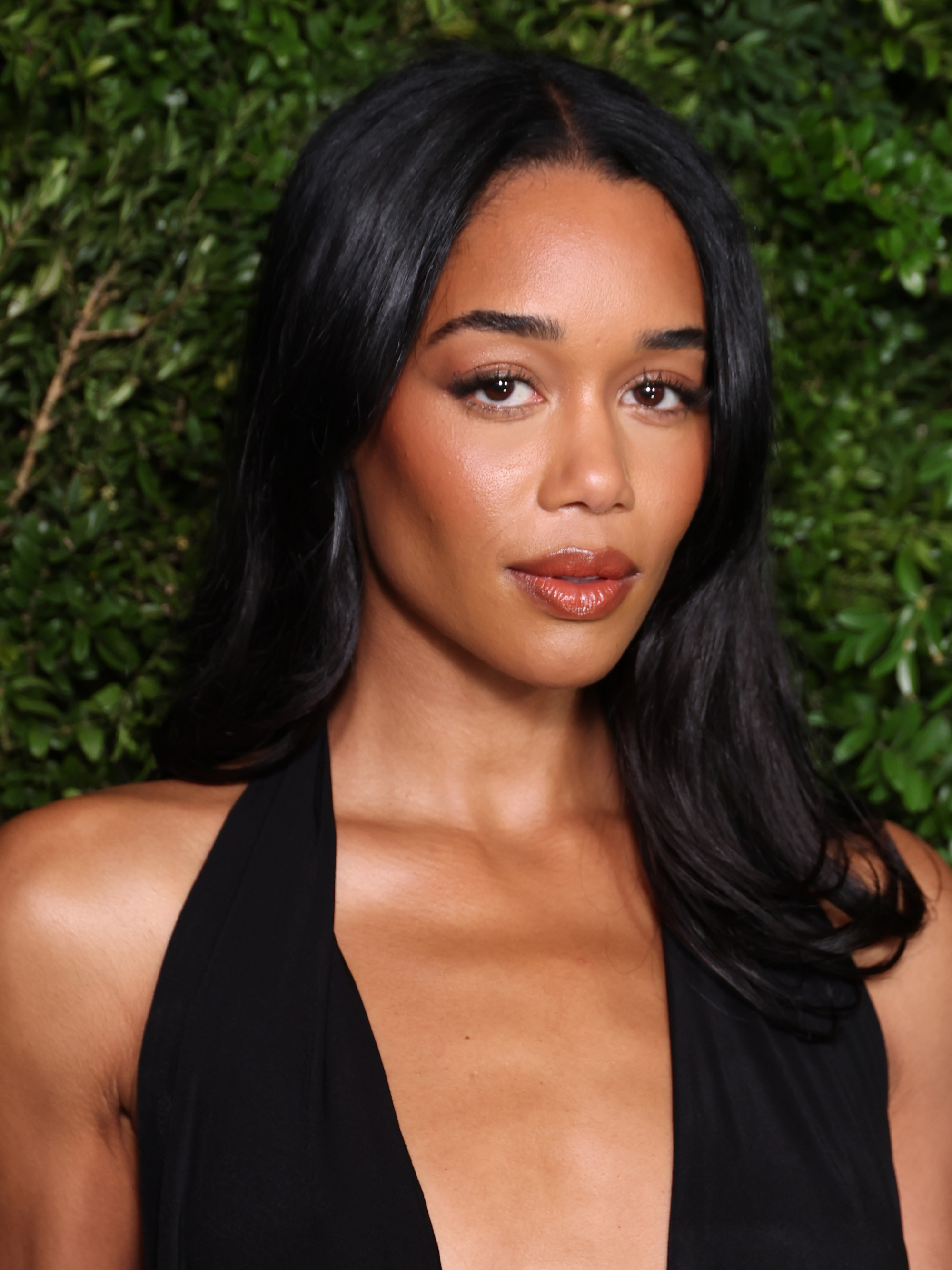 Laura Harrier attends the Charles Finch &amp;amp; Chanel 2026 pre-BAFTA Party with glossy, long hair