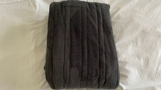 Slumberdown Cosy Hugs Heated Blanket folded on the bed