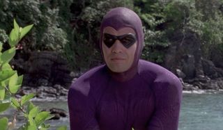 Billy Zane stands costumed, in the bright jungle, in The Phantom.