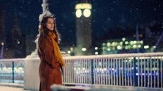 Keira Knightley stands in front of Big Ben in London in the snow