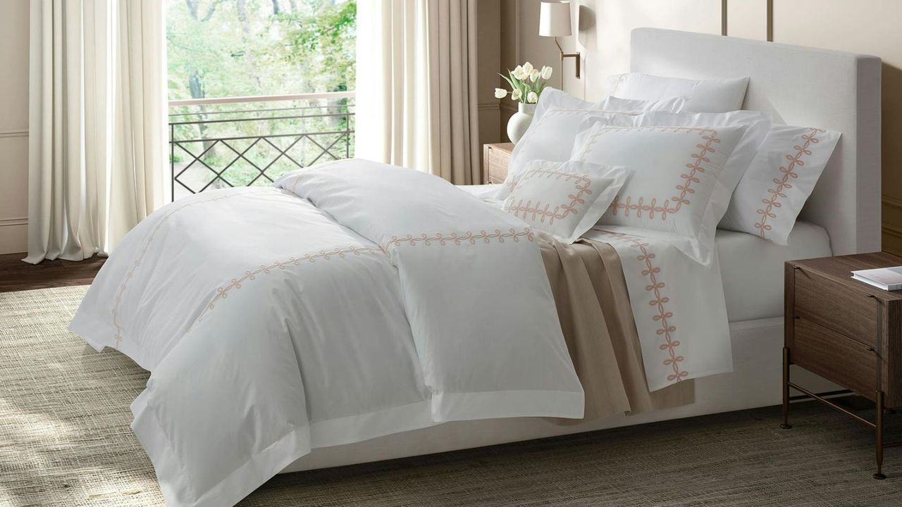 Some of the items in the luxury bedding sales - Matouk Gordian Knot bedding on a bed.