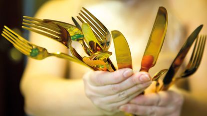Gold-coloured cutlery © Volodko Marina / Alamy Stock Photo