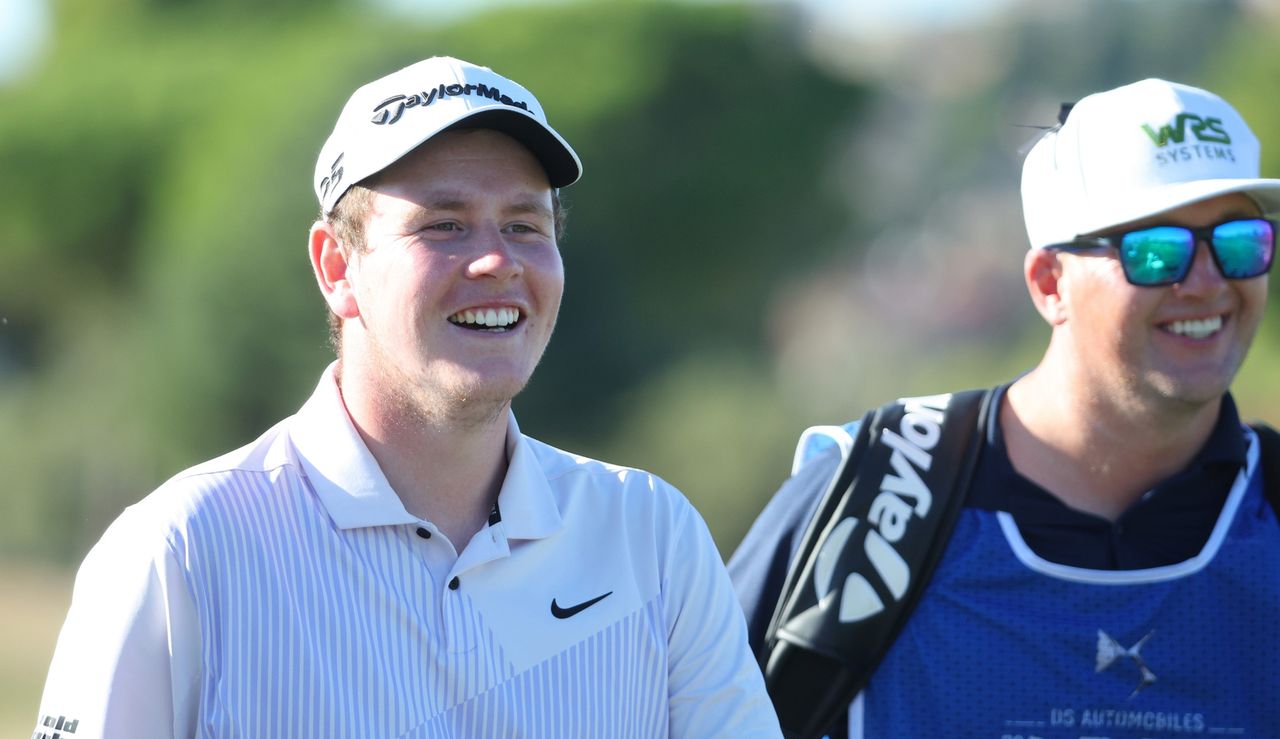 MacIntyre laughs with his caddie