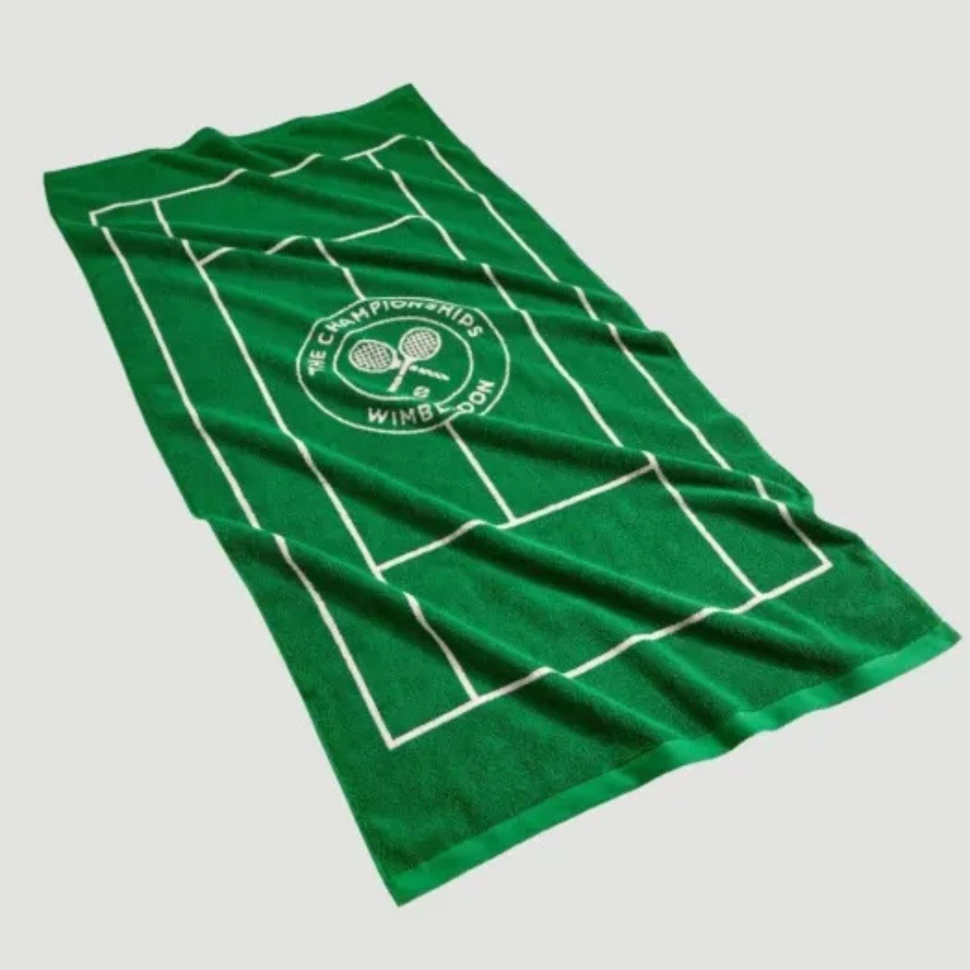 A lifestyle shot of the Wimbledon Tennis Court Cotton Beach Towel