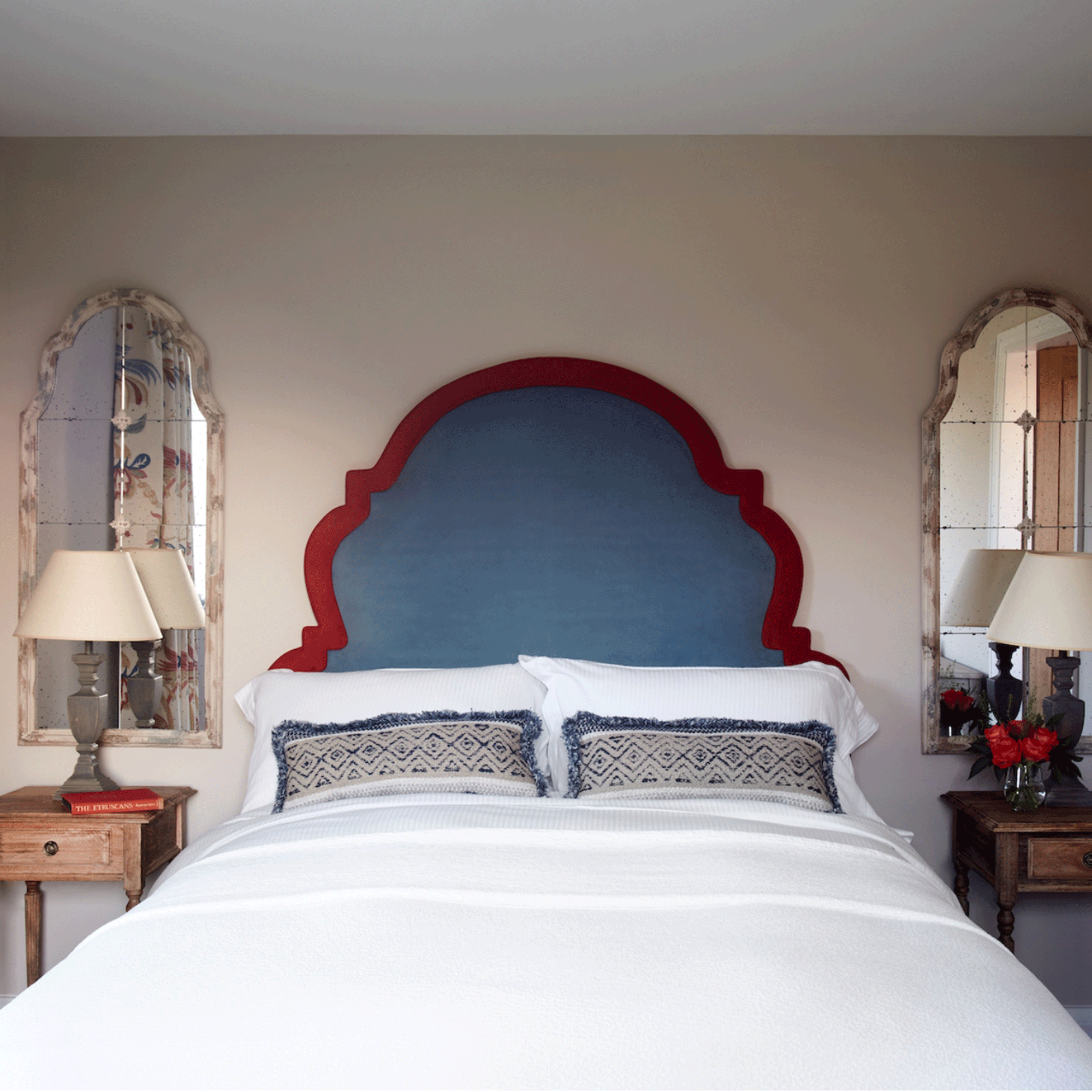 Blue headboard with mirrors in small bedroom